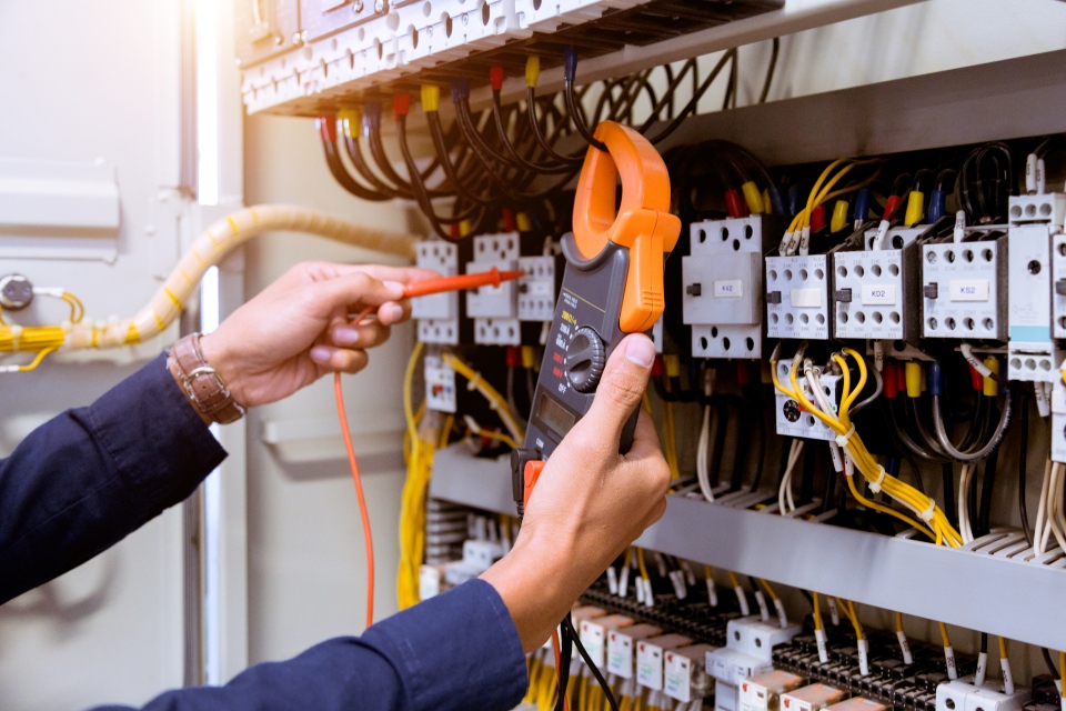 Technician performing electrical tests