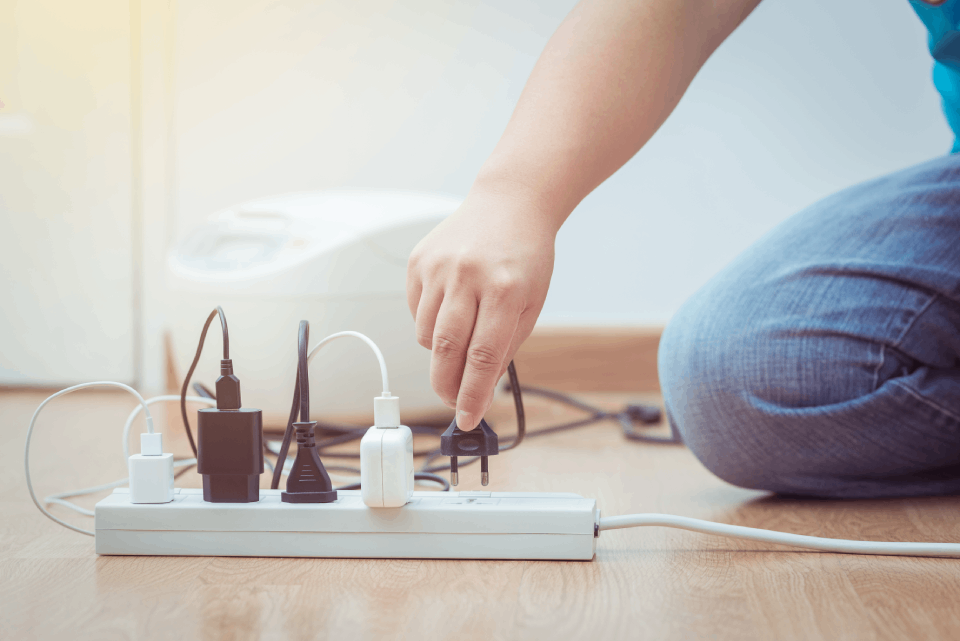 Person plugging electric cable in the circuit